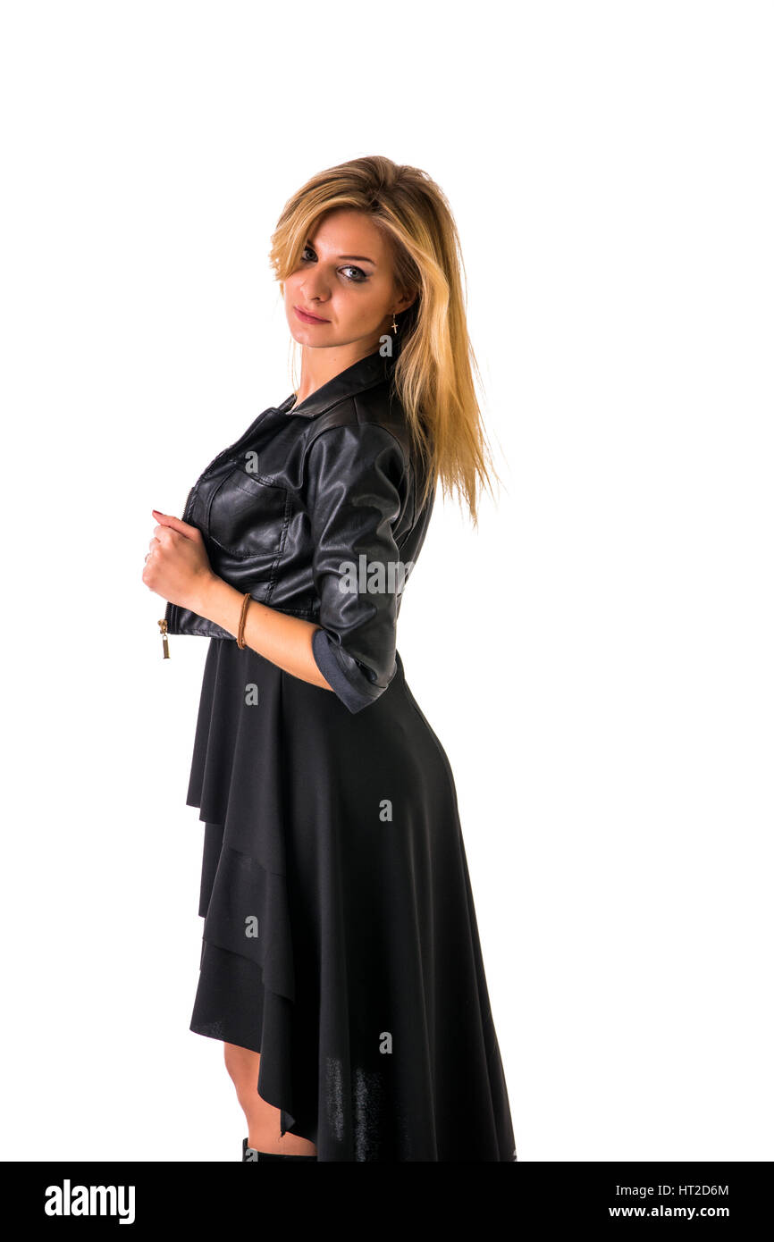Portrait of attractive blonde woman in black skirt and leather jacket looking at camera in studio shot, isolated on white background Stock Photo