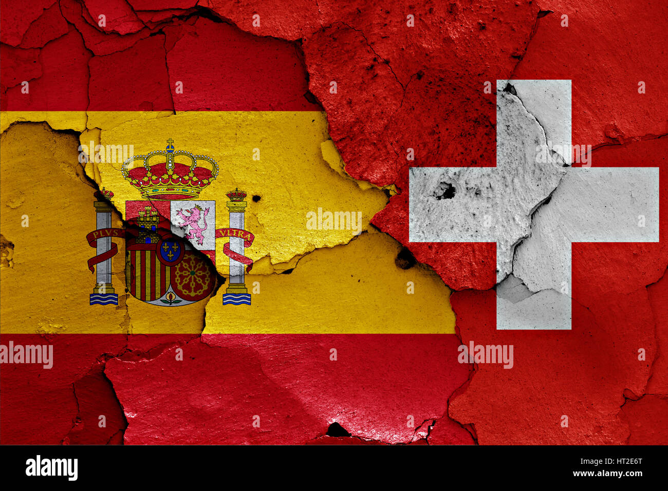 flags of Spain and Switzerland painted on cracked wall Stock Photo