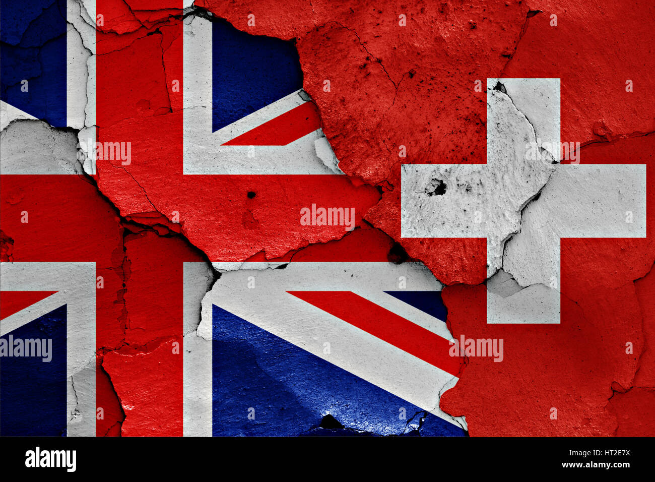 flags of UK and Switzerland painted on cracked wall Stock Photo - Alamy