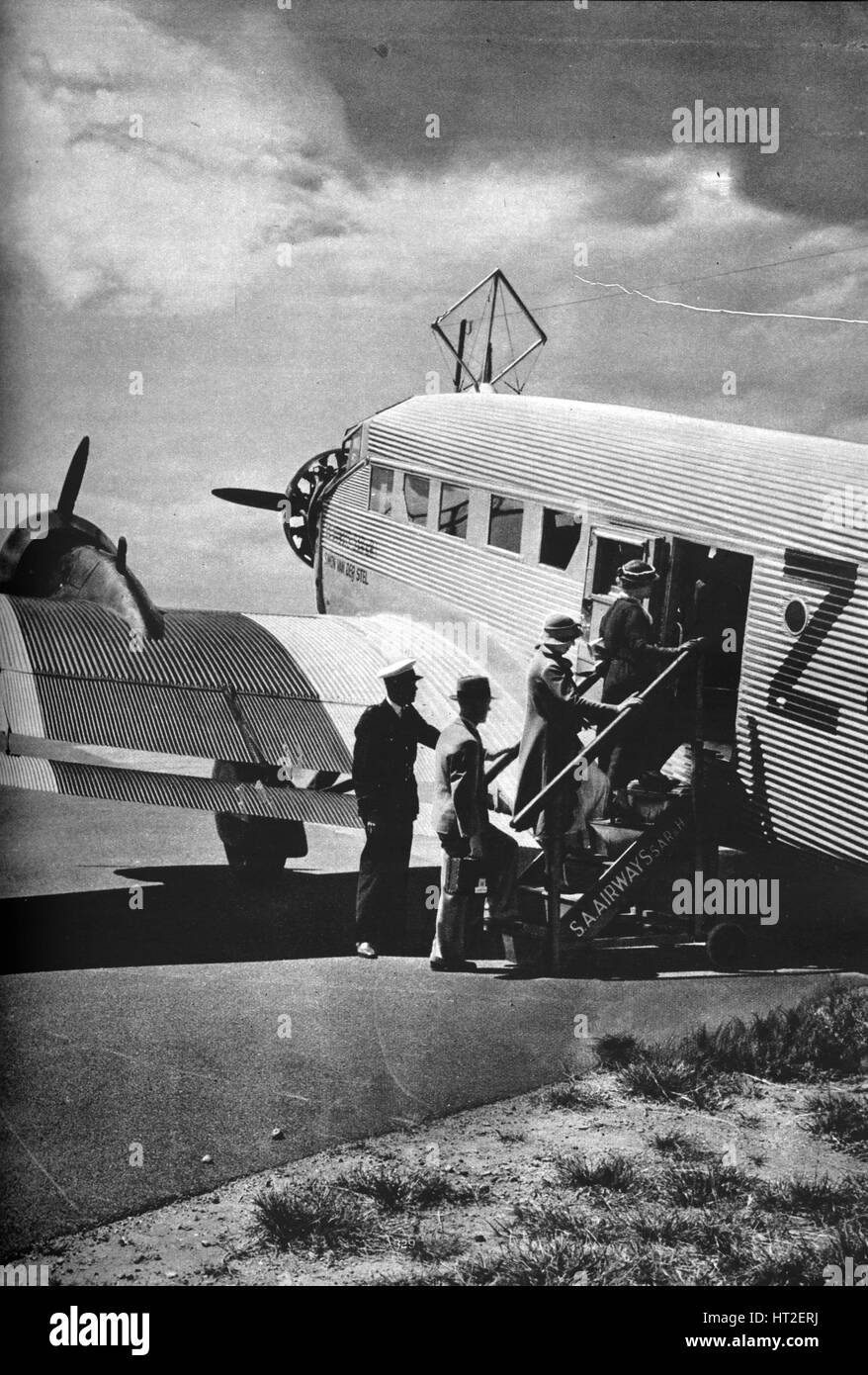 Passengers boarding one of the Junkers airliners of South African Airways, c1936 (c1937). Artist: Unknown. Stock Photo