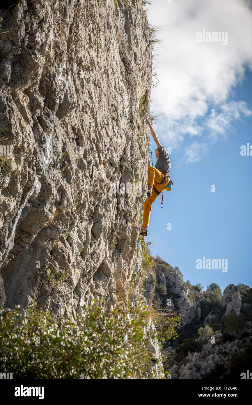 Climber rock climbing on the Costa Blanca, Tarbena, Spain, Europe. Stock Photo