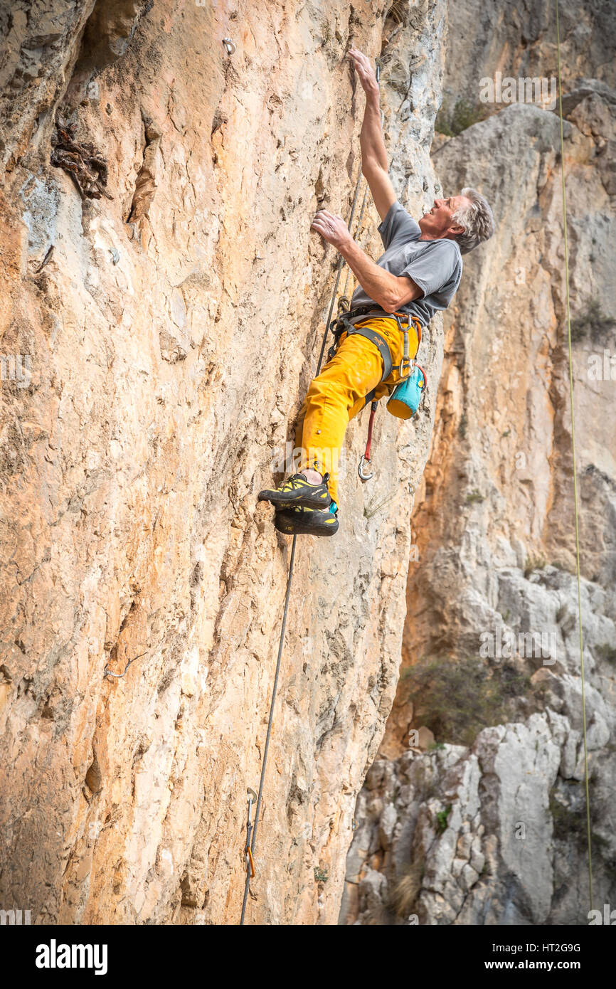 Climber rock climbing on the Costa Blanca, Tarbena, Spain, Europe Stock