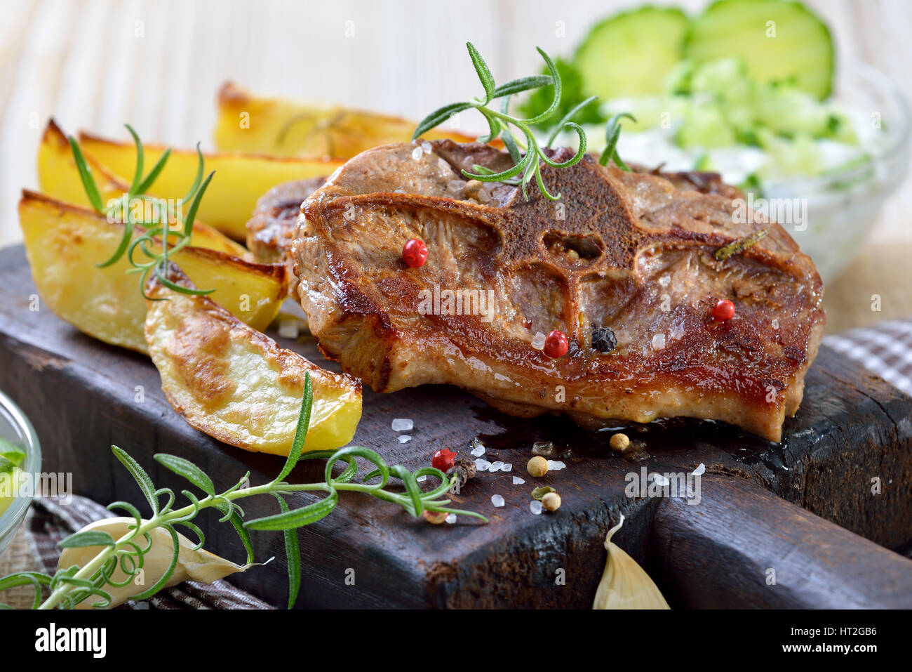 Greek meal Fried lamb chops with baked potato wedges, farmers salad