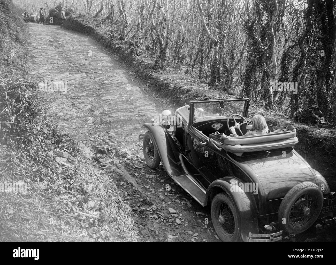 Kitty Brunell driving a 1930 Ford Model A 2-seater, 1931. Artist: Bill Brunell. Stock Photo