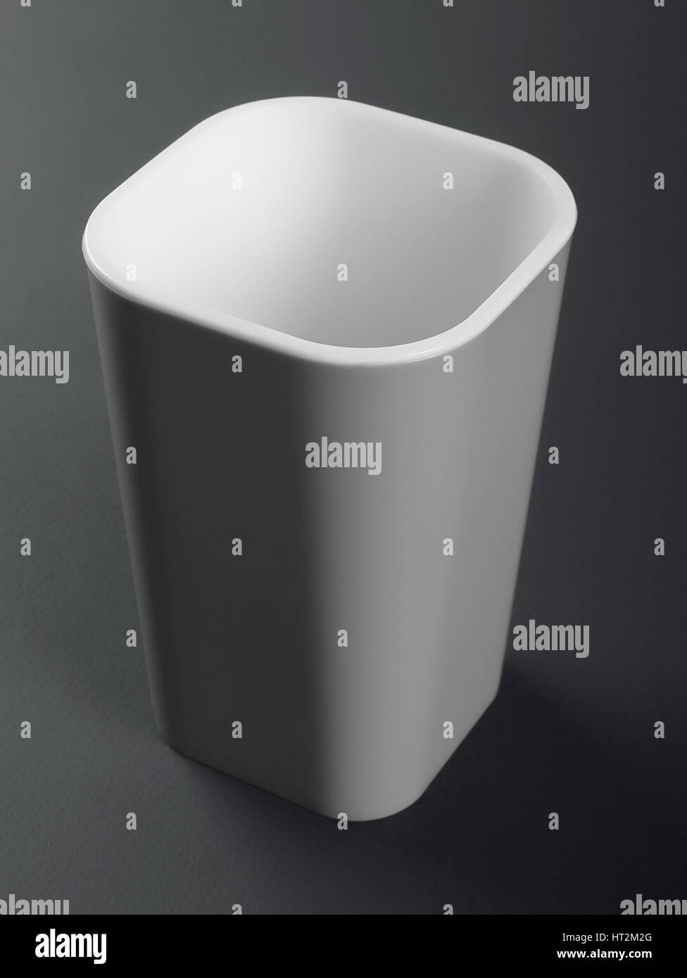 Gray plastic toothbrush holder on gray background Stock Photo Alamy