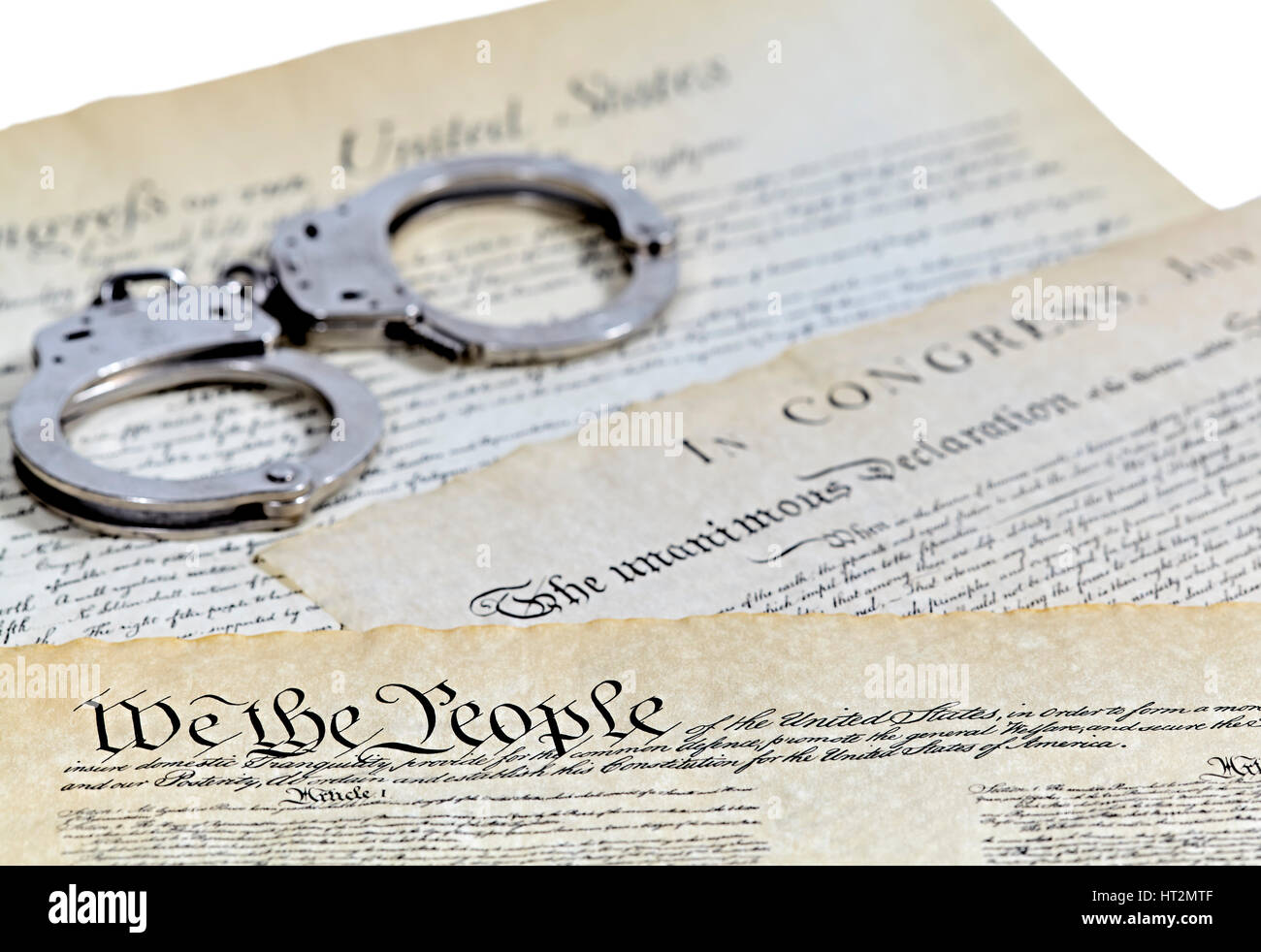 US Constitution with Bill of Rights and Declaration of Independence with handcuffs and shallow depth of field Stock Photo