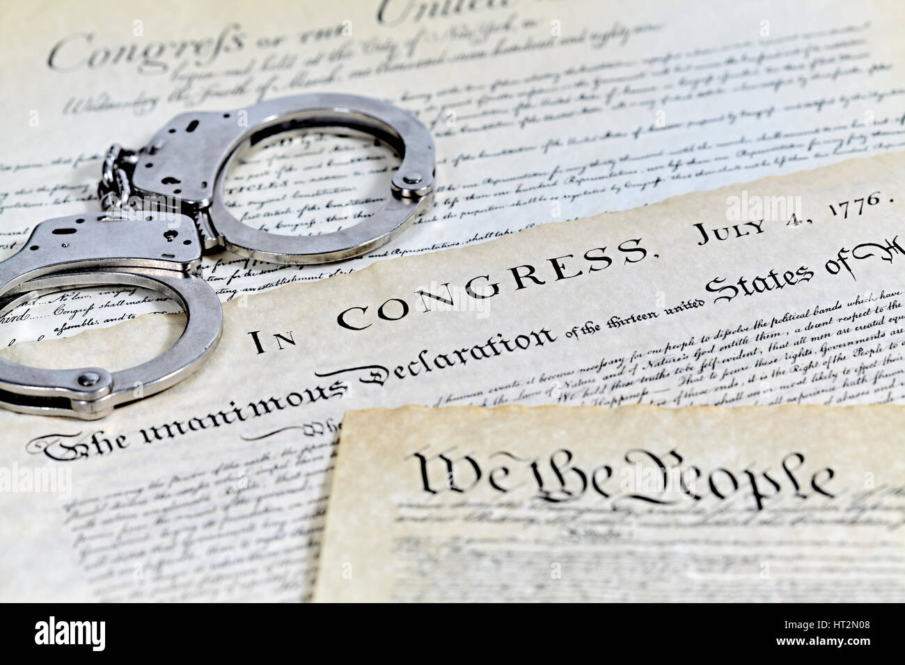 US Constitution with Bill of Rights and Declaration of Independence with handcuffs and shallow depth of field Stock Photo