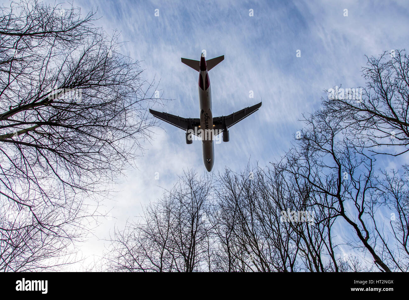 Aviation, plane at Landing approach to DŸsseldorf International Airport, Germany,  trees, Stock Photo