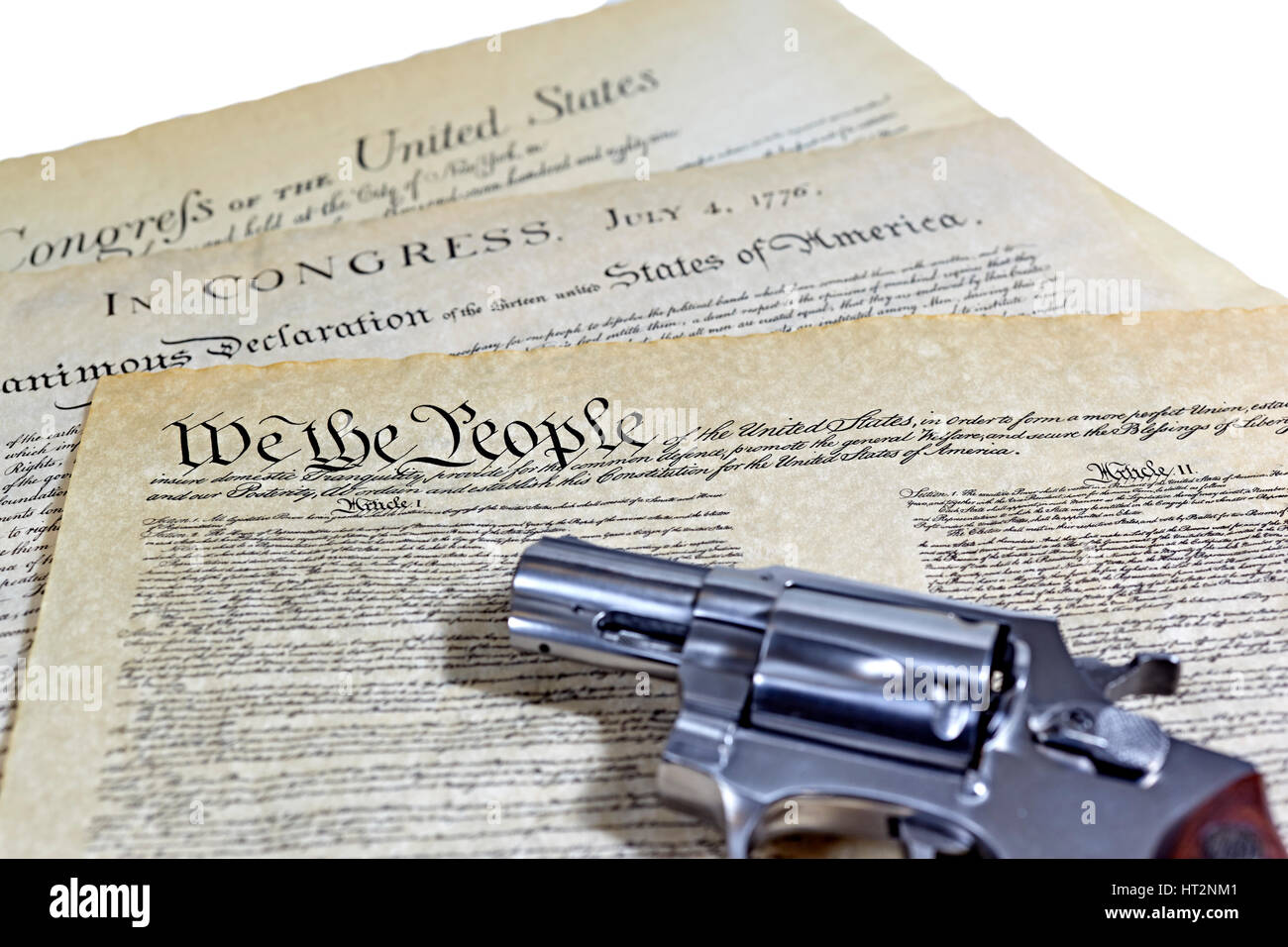 US Constitution with Bill of Rights and Declaration of Independence with a revolver Stock Photo