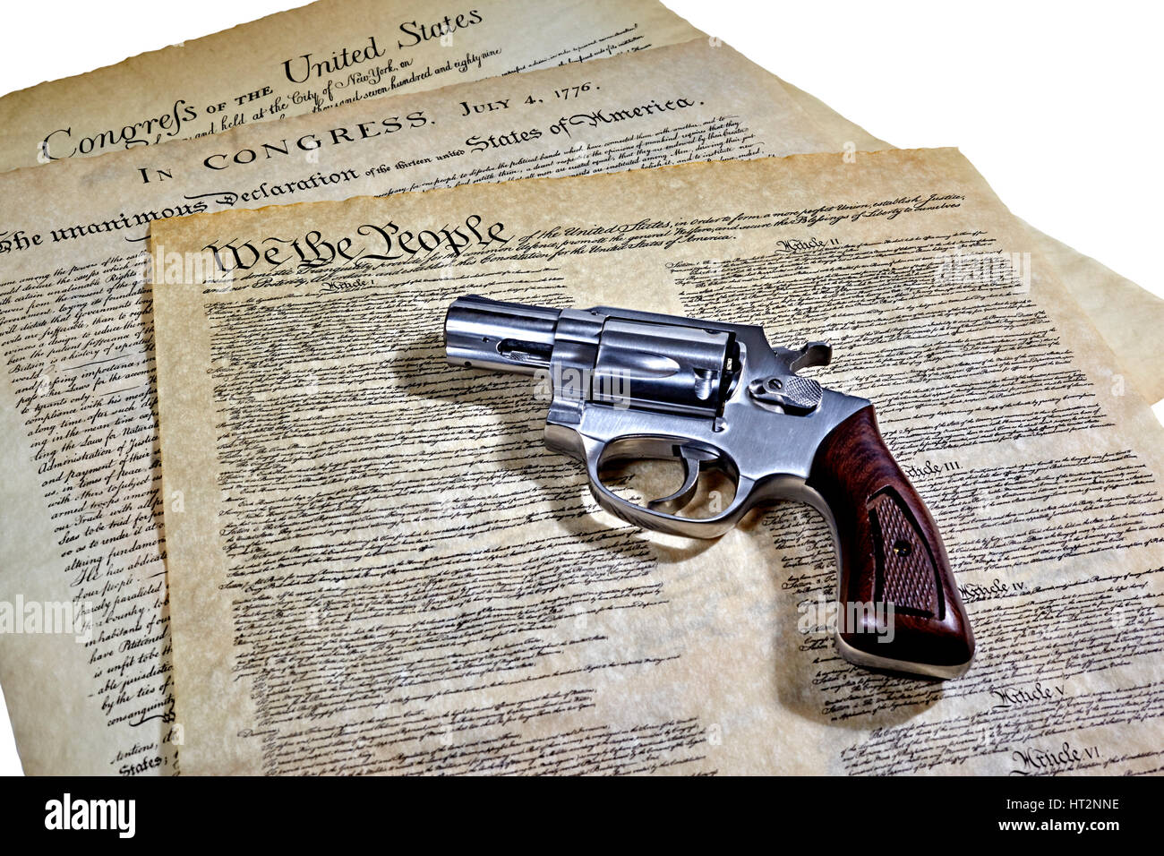 US Constitution with Bill of Rights and Declaration of Independence with a revolver Stock Photo