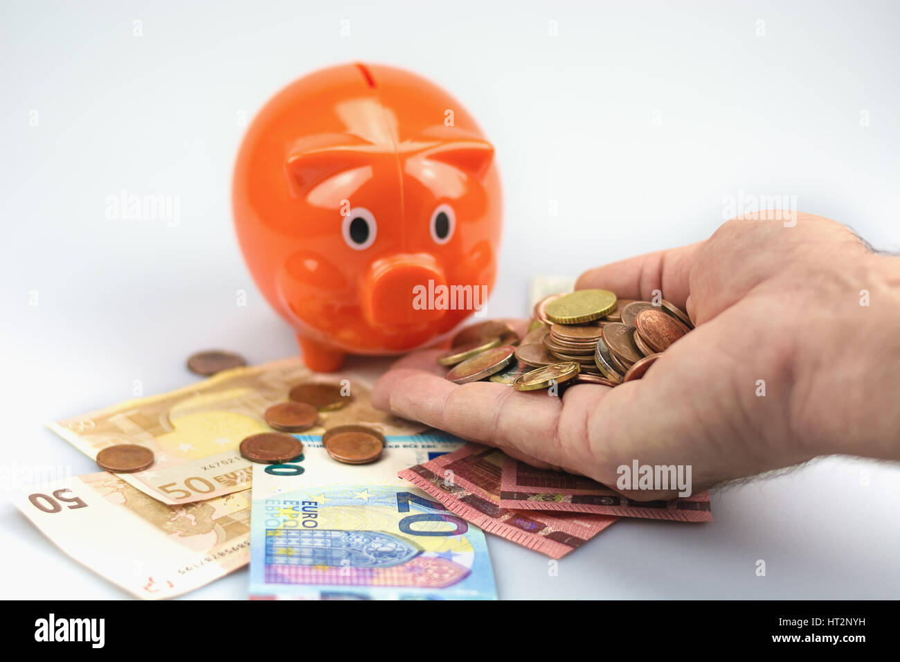 Piggy bank feeded with Euro banknotes and coins Stock Photo - Alamy