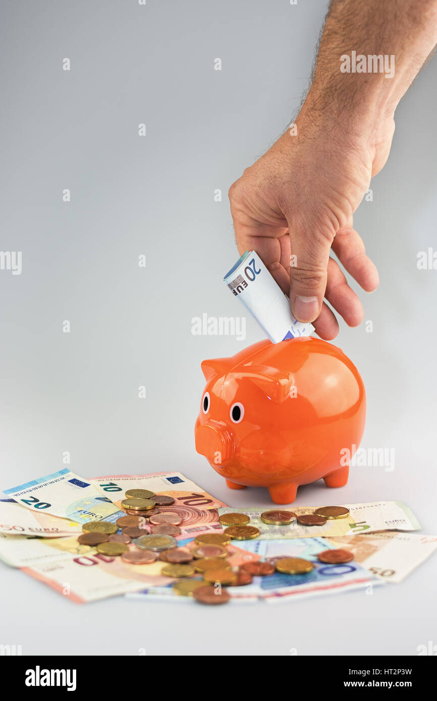 Piggy bank feeded with Euro banknotes and coins Stock Photo - Alamy