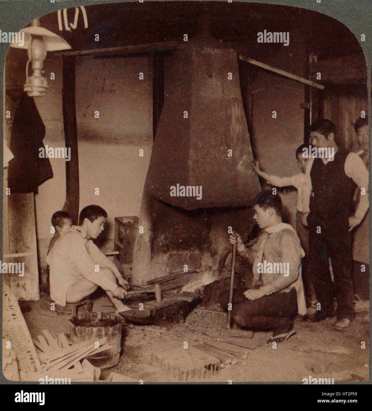 'A Japanese blacksmith at his forge, Yokohama, Japan', 1904. Artist: Unknown. Stock Photo