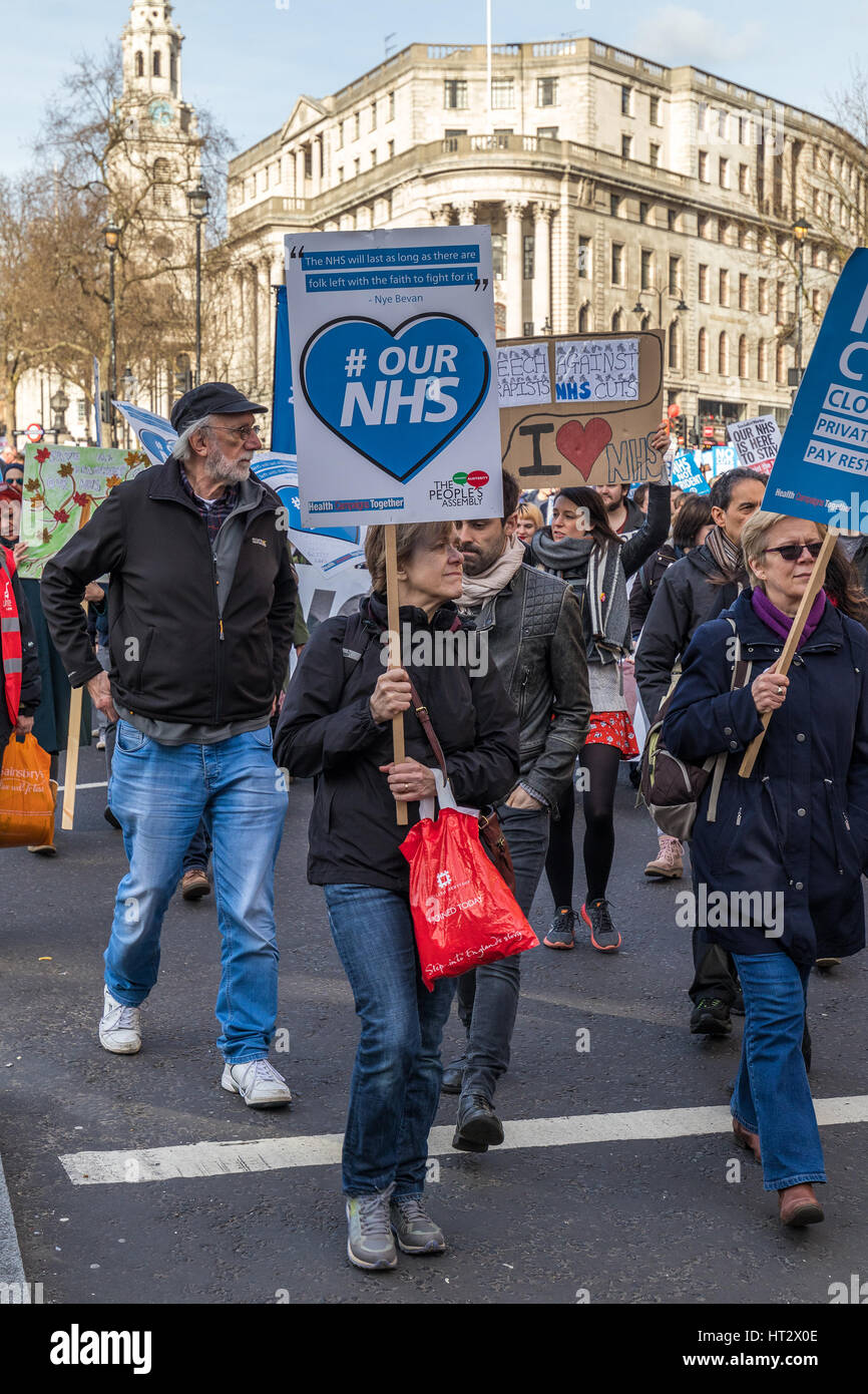 Large group of people walking in the streets of London protesting against cuts and privatisation of NHS Stock Photo