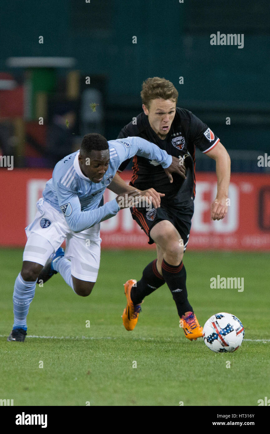 Sporting Kansas City forward Gerso Fernades (7) tackles D.C. United defender Taylor Kemp (2) during D.C. United's home opener against Sporting Kansas City which finished 0-0 at RFK Stadium in Washington, D.C. on Saturday March 4, 2017. Stock Photo