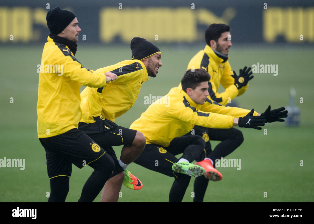 Dortmund, Germany. 7th Mar, 2017. Borussia Dortmund players (l to r) Marcel Schmelzer, Pierre-Emerick Aubameyang, Marc Bartra and Nuri Sahin stretch on the training grounds in Dortmund, Germany, 7 March 2017. BVB will meet Benfica Lissabon in the second round second legs of the Champions League (8.03.). Photo: Bernd Thissen/dpa/Alamy Live News Stock Photo