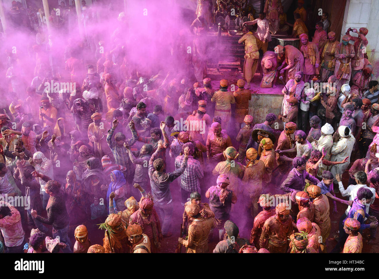 Mathura, Indian state of Uttar Pradesh. 7th Mar, 2017. Villagers daubed with color powder celebrate Lath Mar Holi in Mathura, northern Indian state of Uttar Pradesh, on March 7, 2017. Lath Mar Holi is a local annual festival celebrated in neighbouring towns near Mathura, as part of the yearly grand Holi festival. It takes place a couple of days ahead of the actual Holi day. Credit: Stringer/Xinhua/Alamy Live News Stock Photo
