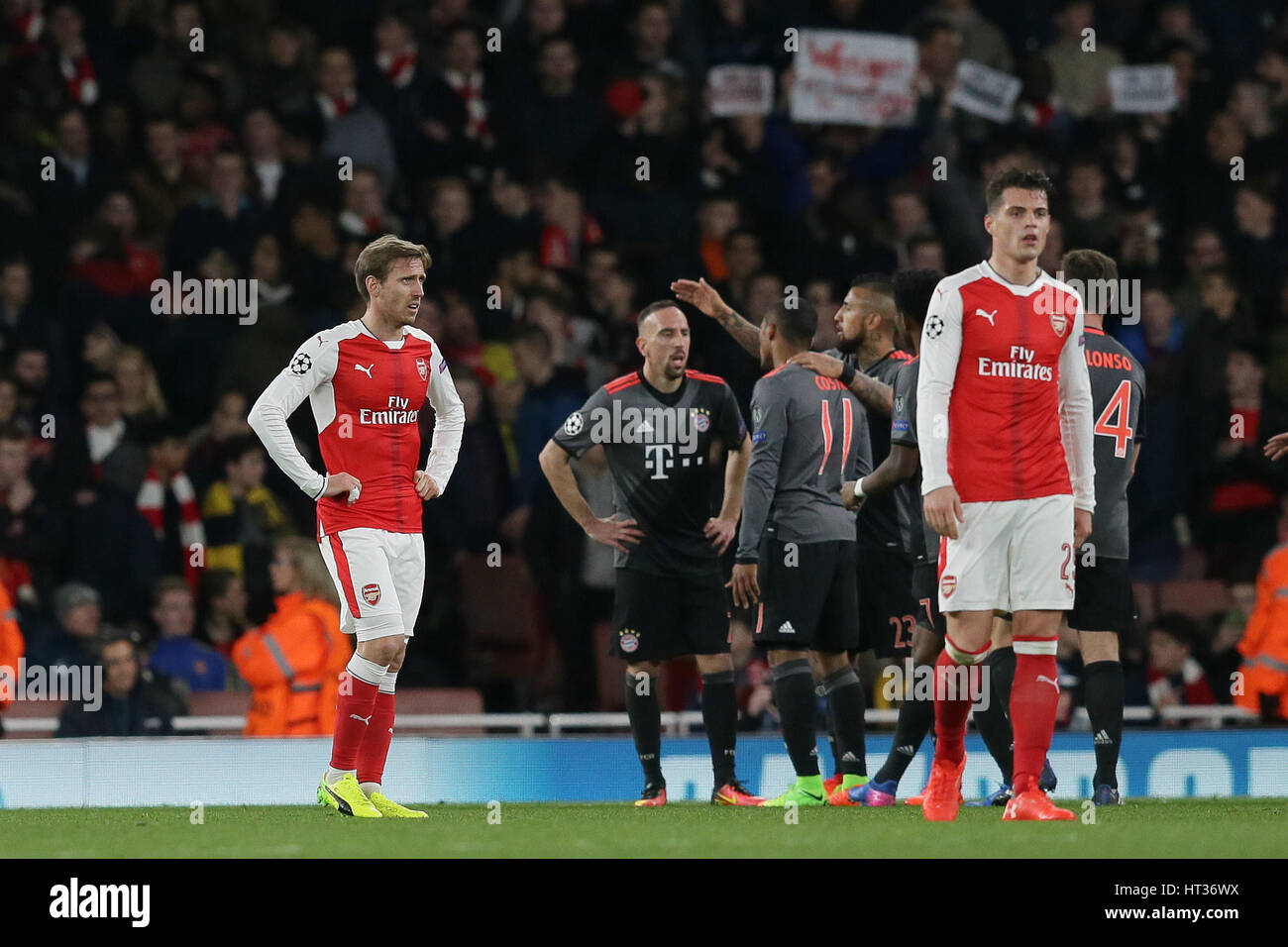 London, UK. 7th Mar, 2017. Nacho Monreal(1st L) and Granit Xhaka of Arsenal look dejected during the UEFA Champions League Round of 16 second leg match between Arsenal and Bayern Munich in London, Britain on March 7, 2017. Bayern Munich won 5-1 and advanced to the quarterfinal with 10-2 on aggregate. Credit: Tim Ireland/Xinhua/Alamy Live News Stock Photo