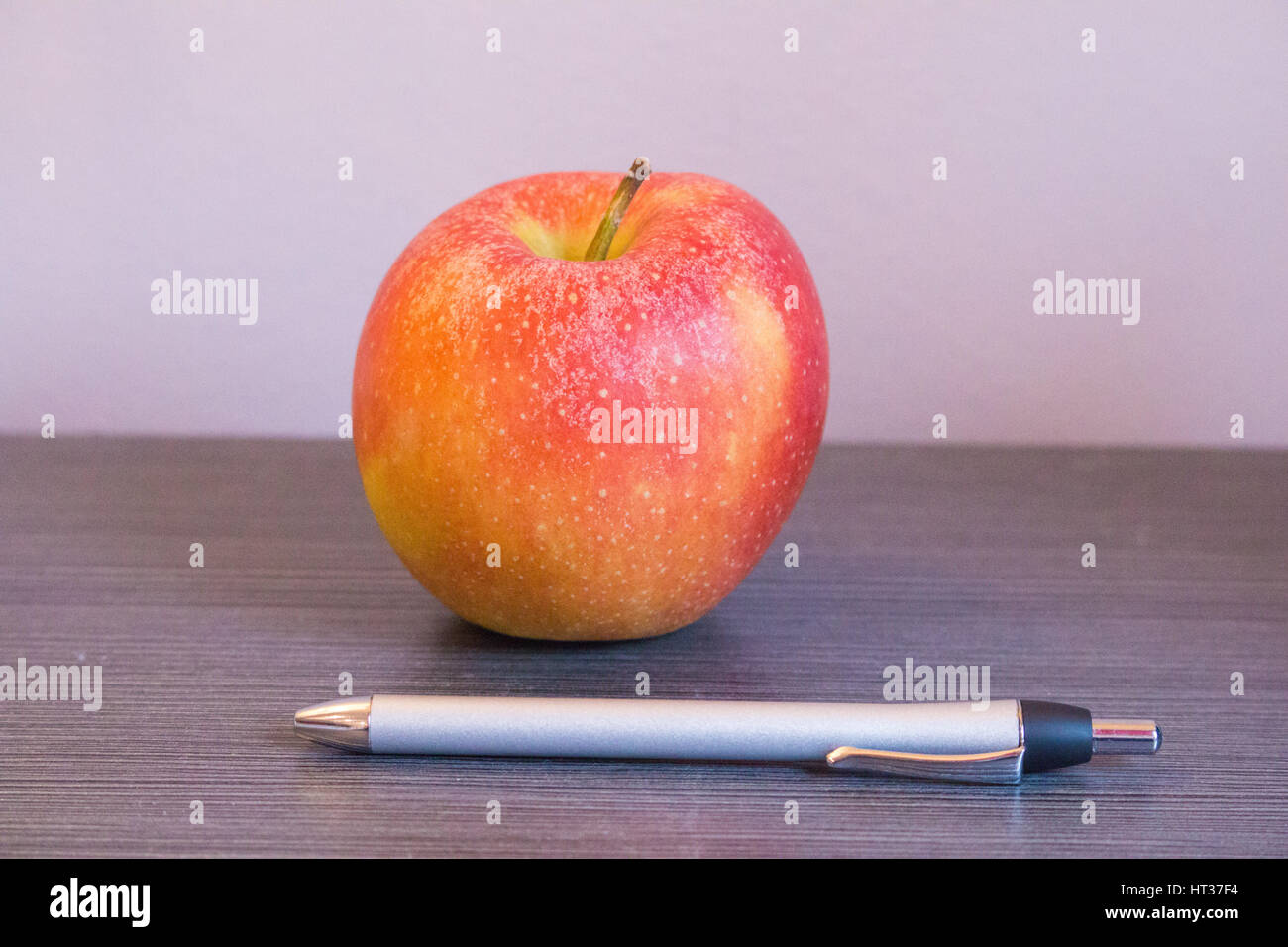 Apple and pen Stock Photo