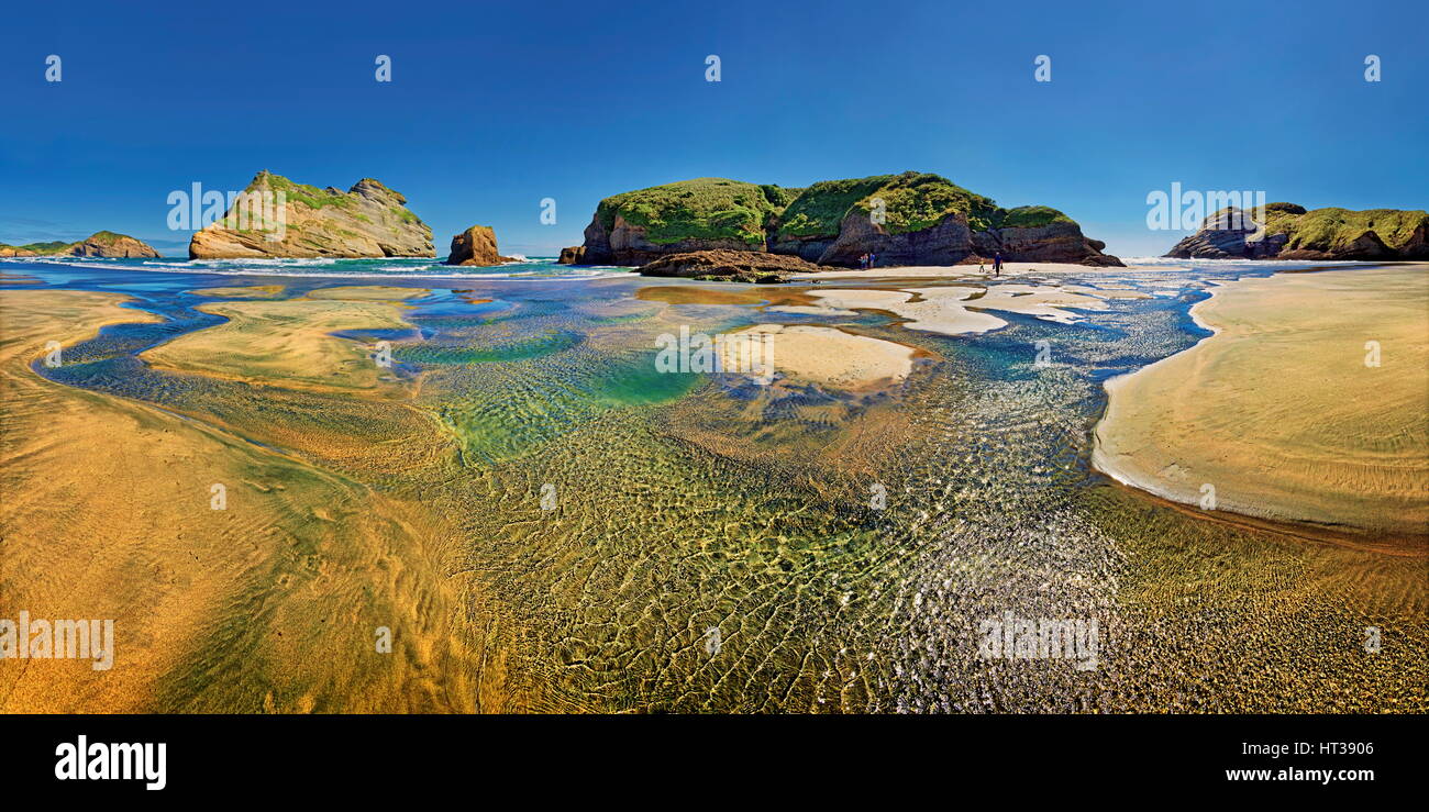 Sandy beach with receding water and rocky island in the surf, Archway Islands, Wharariki Beach, Cape Farewell, Puponga Stock Photo