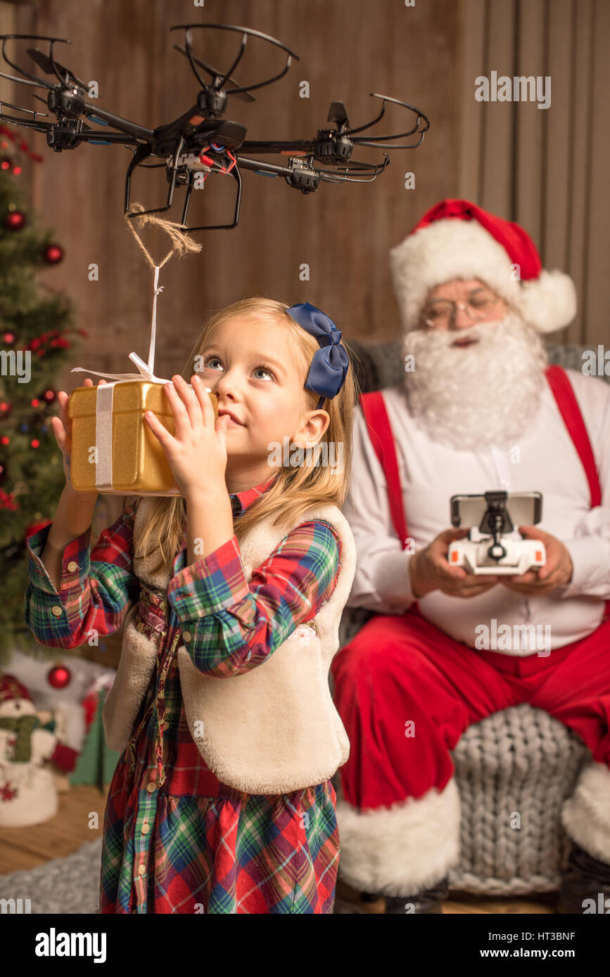 Santa with kid using hexacopter drone Stock Photo - Alamy