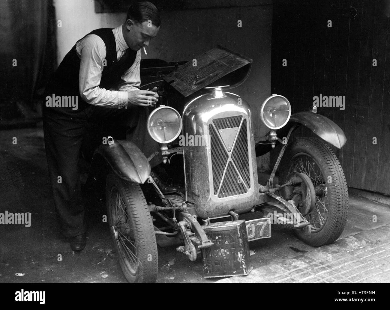 Geoffrey Baker working on a Salmson 1090cc car. Artist: Bill Brunell. Stock Photo
