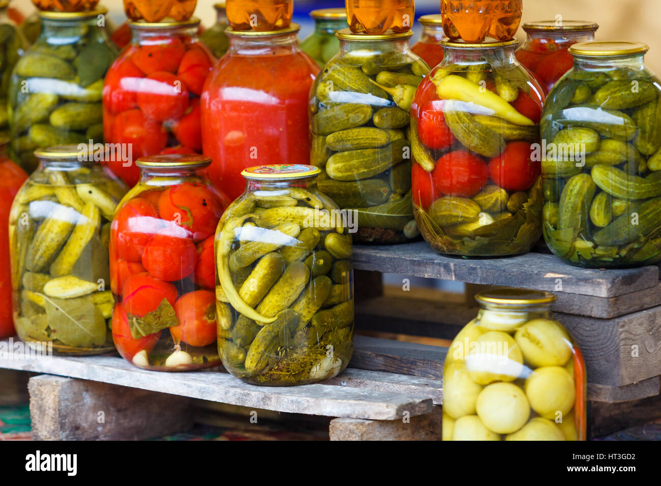 Jars with pickled vegetables. Preserved vegetables. tomatoes and