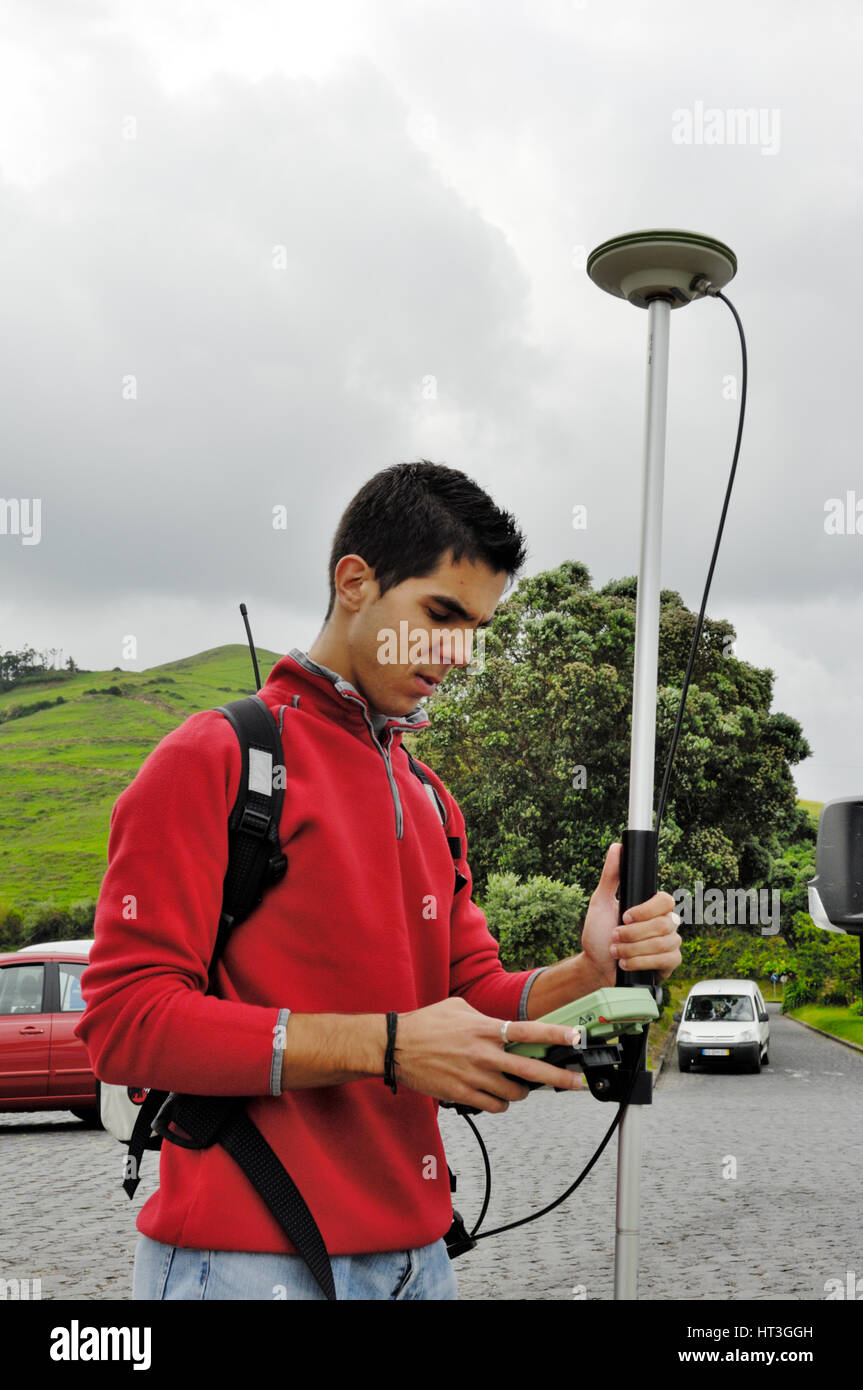 Surveyor using high accuracy GPS surveying instrument Stock Photo