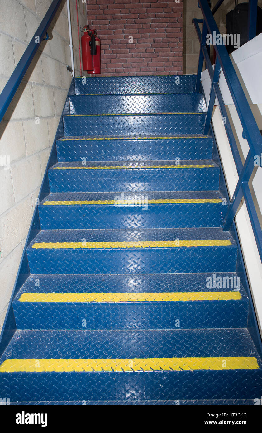 A blue painted metal staircase in a working environment Stock Photo