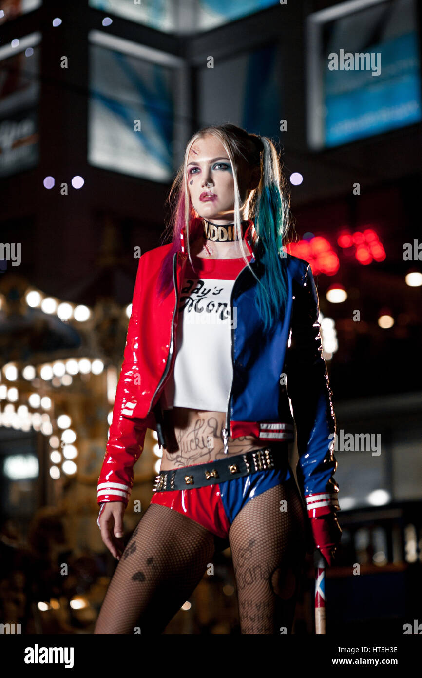 Cosplayer girl in costume Harley Quinn on background lights of night city.  Cosplay Stock Photo - Alamy