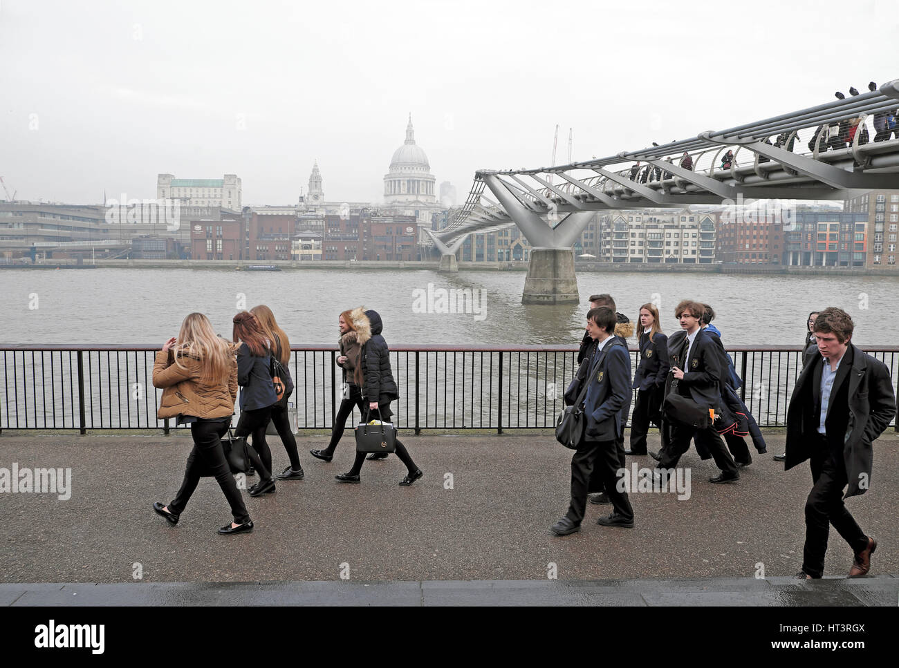 A group of students walking near the Millennium Bridge in London, UK  KATHY DEWITT Stock Photo