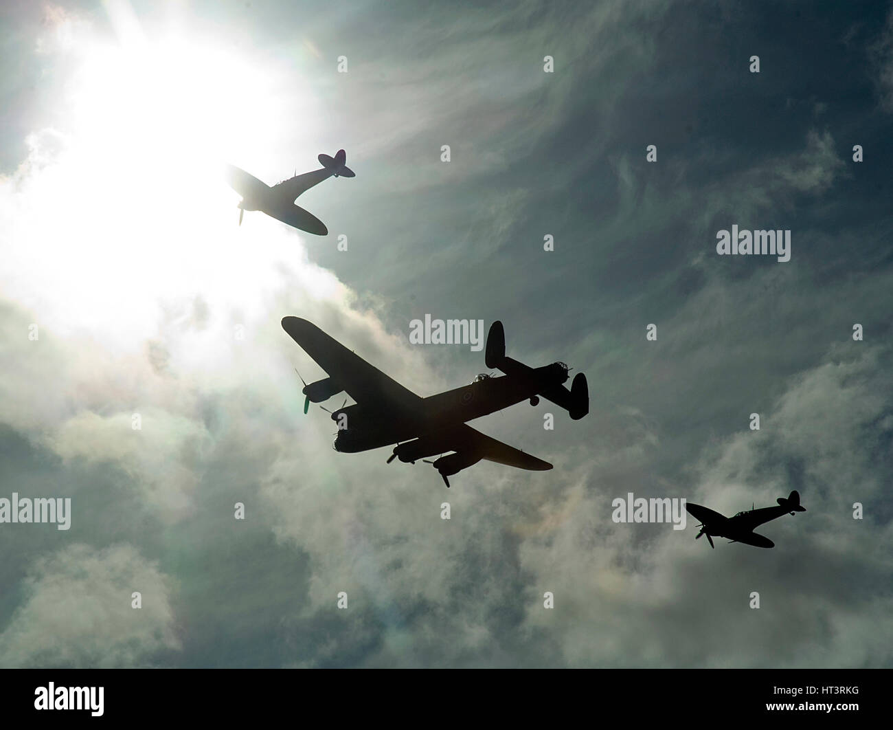 2011 Goodwood Revival Meeting, Lancaster bomber and 2 Spitfires in aerial display. Artist: Unknown. Stock Photo