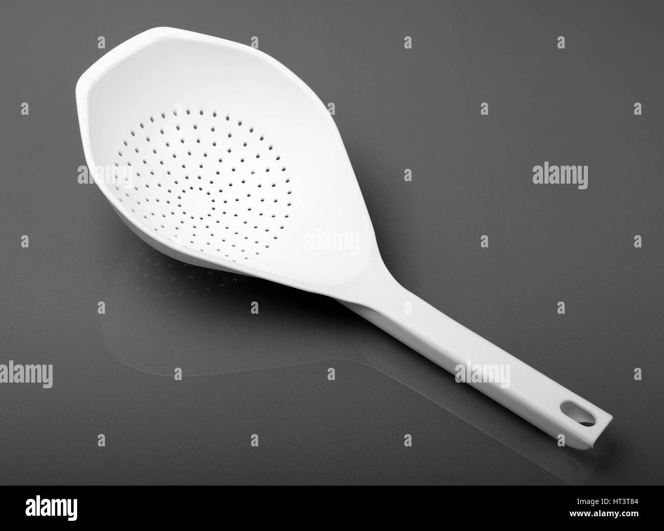 Plastic strainer with handle, a modern kitchen utensil Stock Photo Alamy