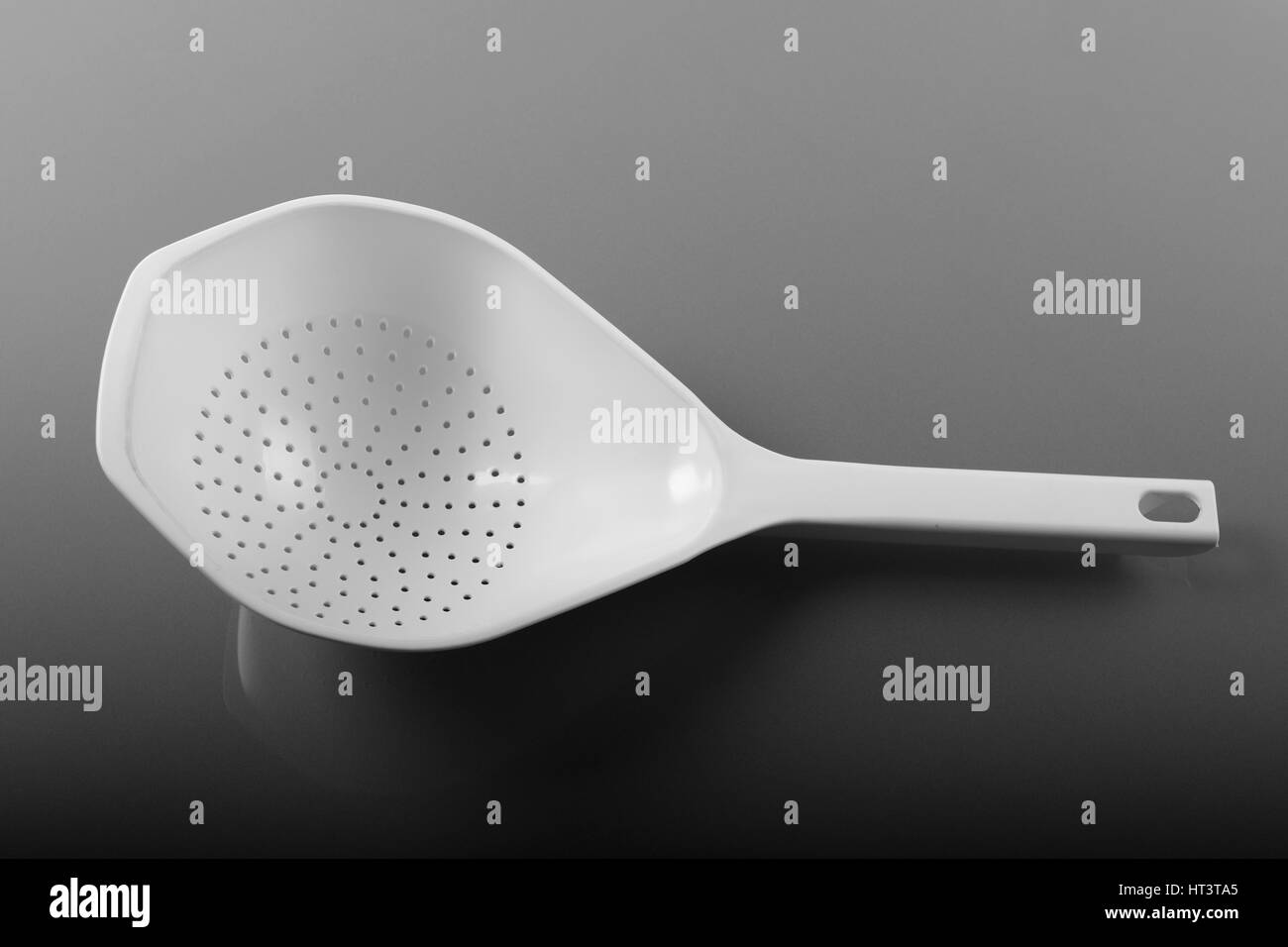 Plastic strainer with handle, a modern kitchen utensil Stock Photo Alamy