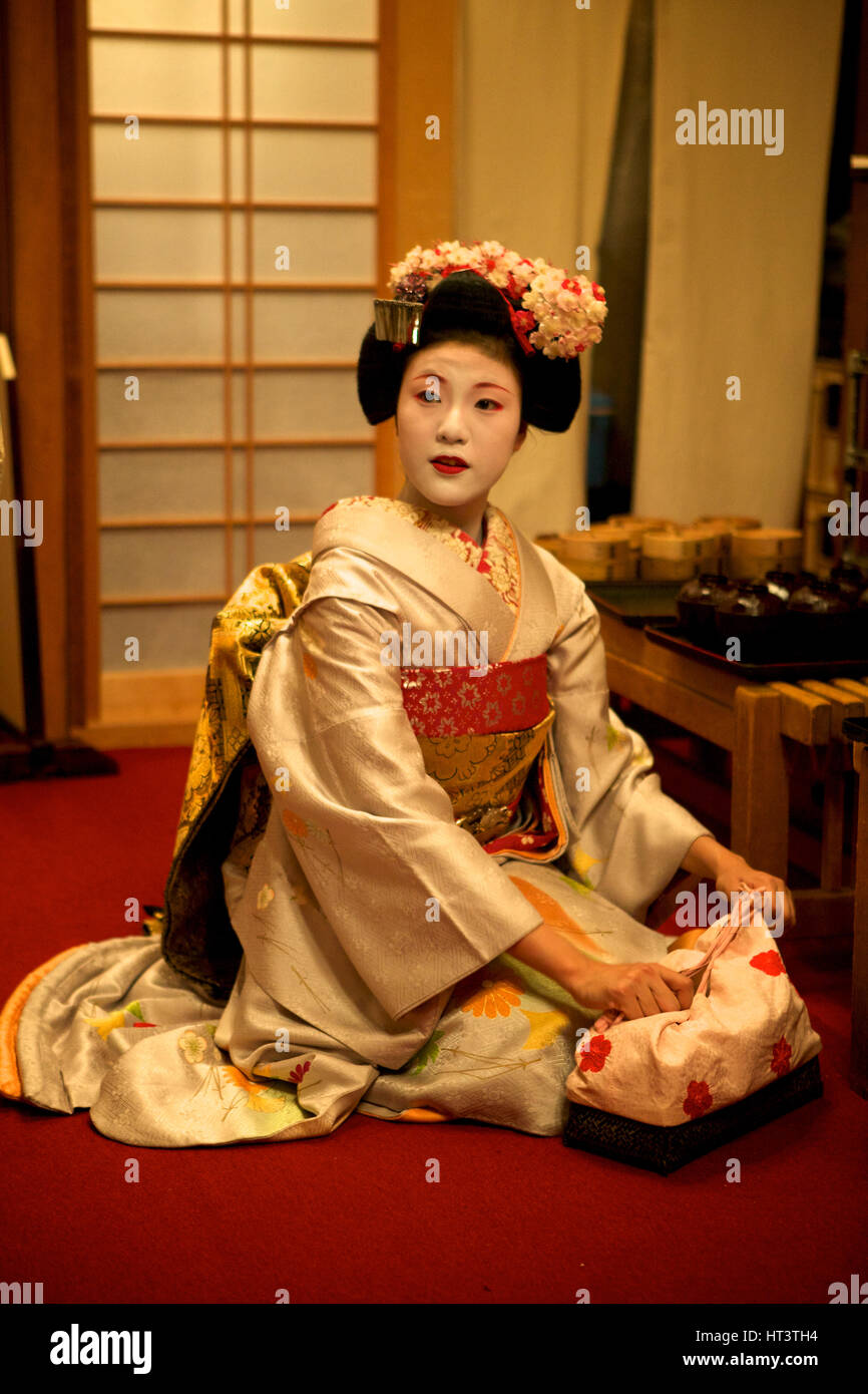 Geisha prepares herself for entertaining a group in a restaurant, Gion District, Kyoto Japan. Stock Photo