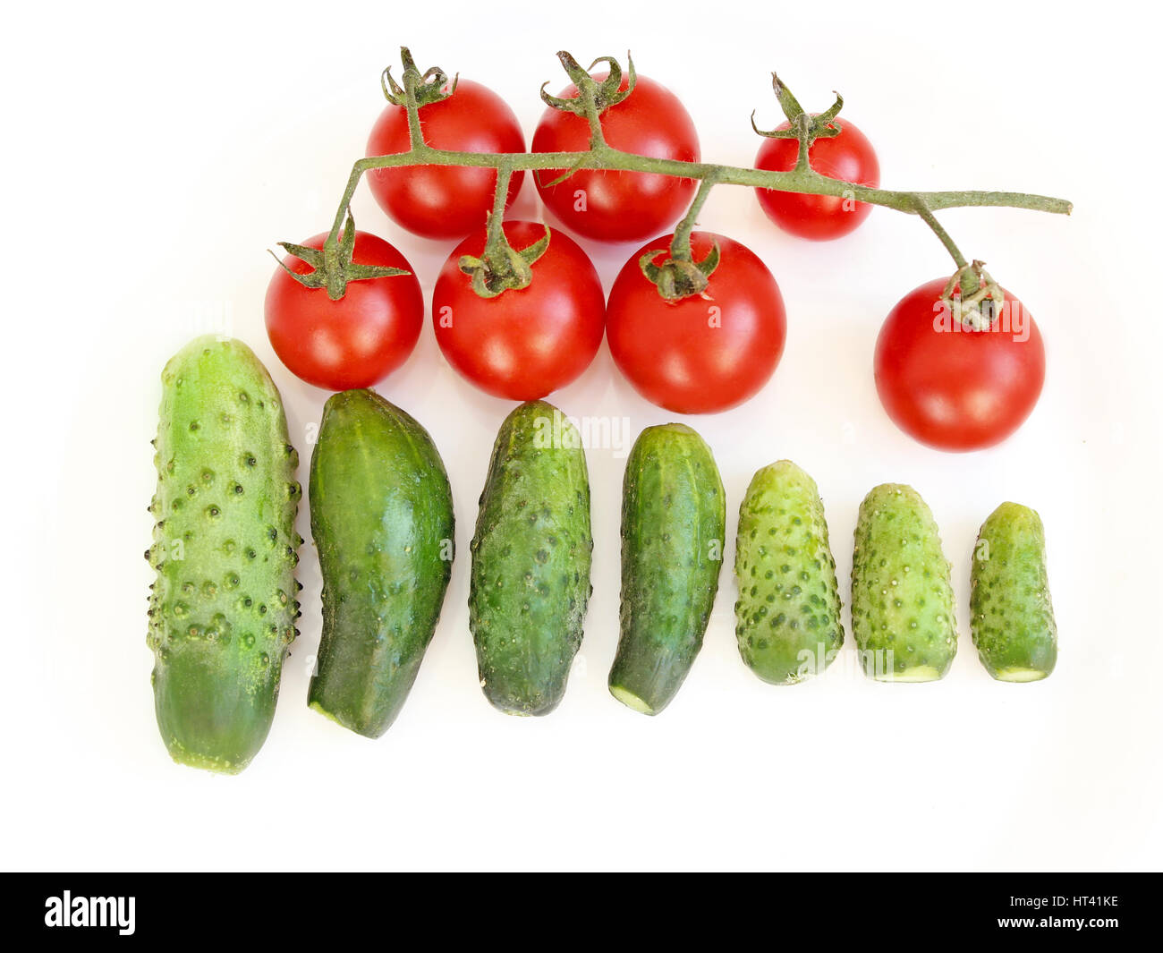 fresh cucumbers and branch of red tomatoes isolated on the white Stock ...