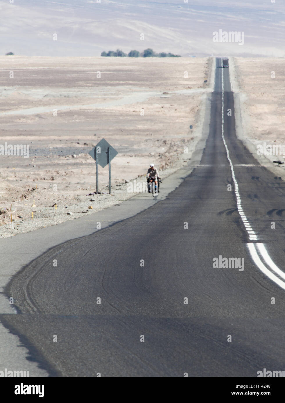 Long distance cyclist biking by Panamerican Highway through teh Atacama desert, Chile Stock Photo