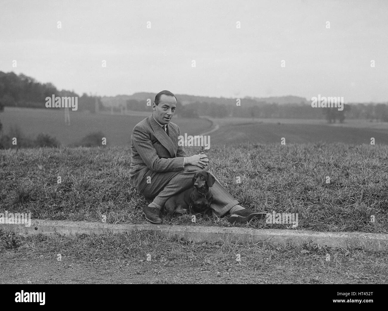 British racing driver Charles Mortimer and his pet dachshund, c1930s Artist: Bill Brunell. Stock Photo