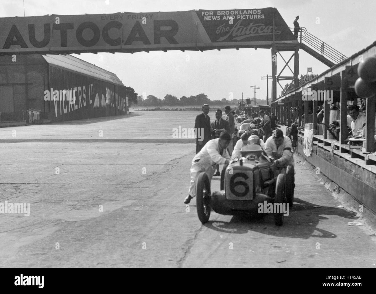 'Rubber Duck', works Austin 7 of Charles Goodacre in the pits, BRDC 500 Mile Race, Brooklands, 1931. Artist: Bill Brunell. Stock Photo