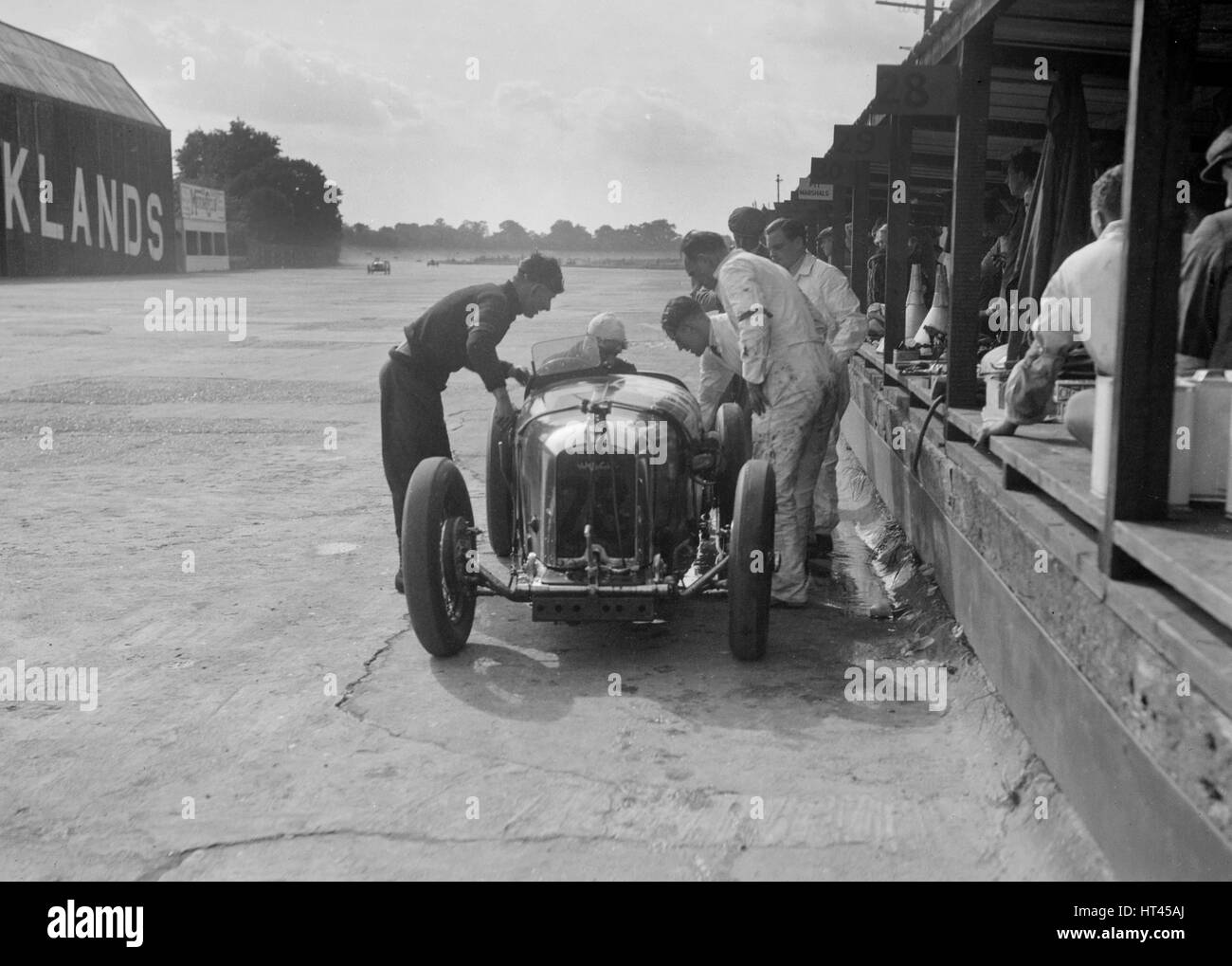 Amilcar C6 of Bill Humphreys in the pits, BRDC 500 Mile Race, Brooklands, 1931. Artist: Bill Brunell. Stock Photo