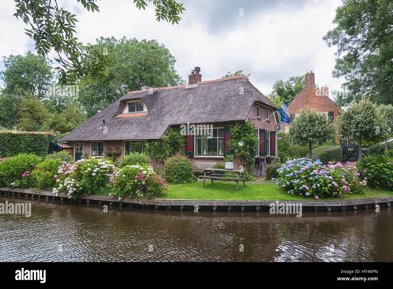 Giethoorn, Netherlands - June 29, 2016: View of a blooming garden in front of the house of the Dutch town. Stock Photo