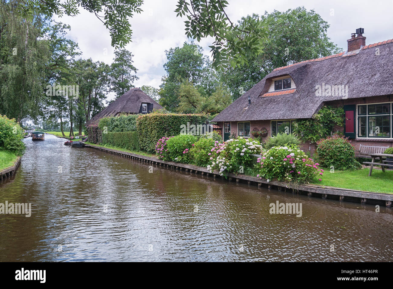 Giethoorn, Netherlands – June 29, 2016: View of a blooming garden in front of the house of the Dutch town Giethoorn. Stock Photo