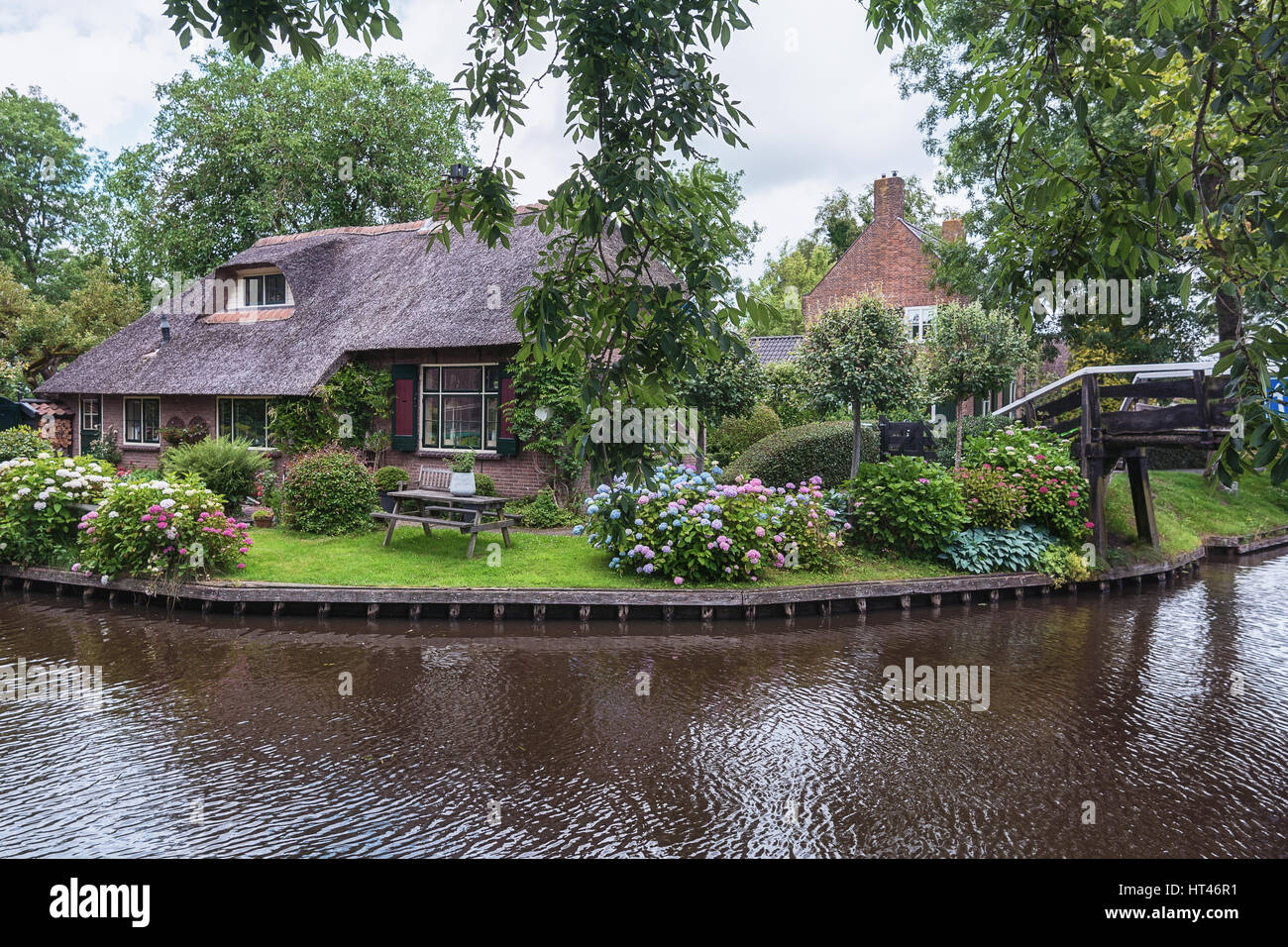 Giethoorn, Netherlands – June 29, 2016: View of a blooming garden in front of the house of the Dutch town. Stock Photo