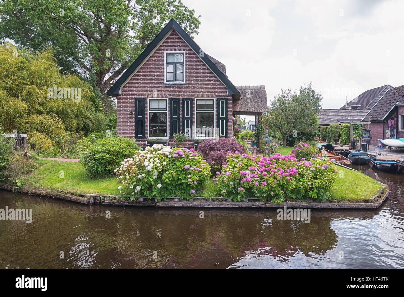 View of a blooming garden in front of the house of the Dutch town Giethoorn. Stock Photo