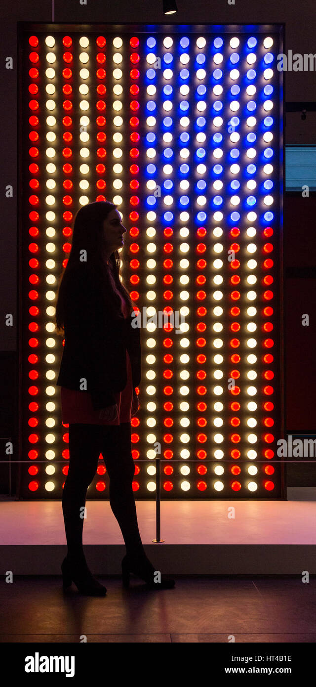 London, UK. 6 March 2017. British Museum employees pose in front of a light installation of the American Flag at the entrance to the exhibition. The exhibition 'The American Dream: pop to the present' opens at the British Museum on 9 March and runs until 18 June 2017. The American Dream is the UK's first major exhibition to chart modern and contemporary American printmaking and has more than 200 works by 70 artists on display. it is sponsored by Morgan Stanley and supported by the Terra Foundation for American Art. Stock Photo