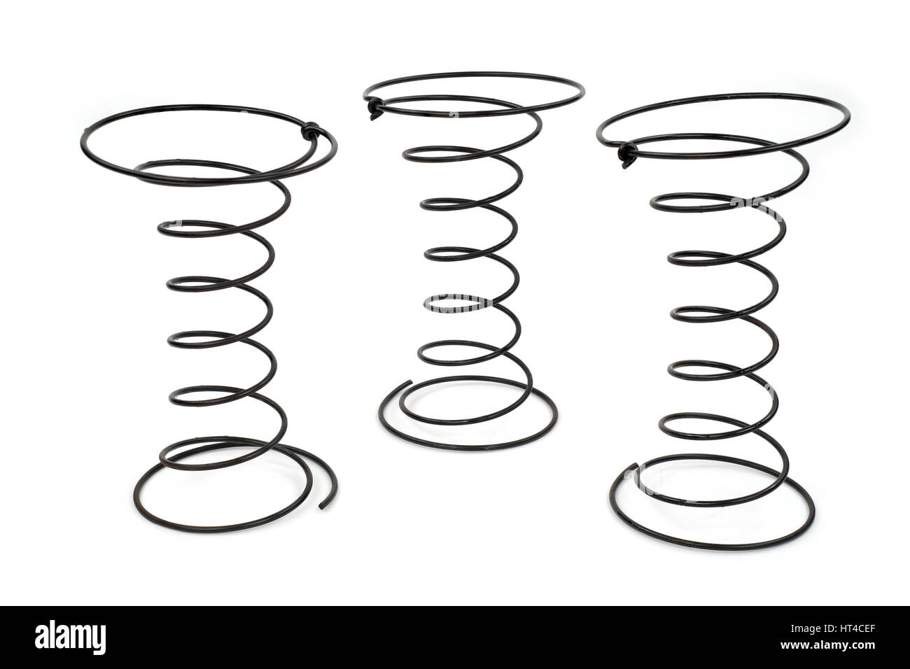 Three Black Wire Springs used in Upholstery on white background Stock