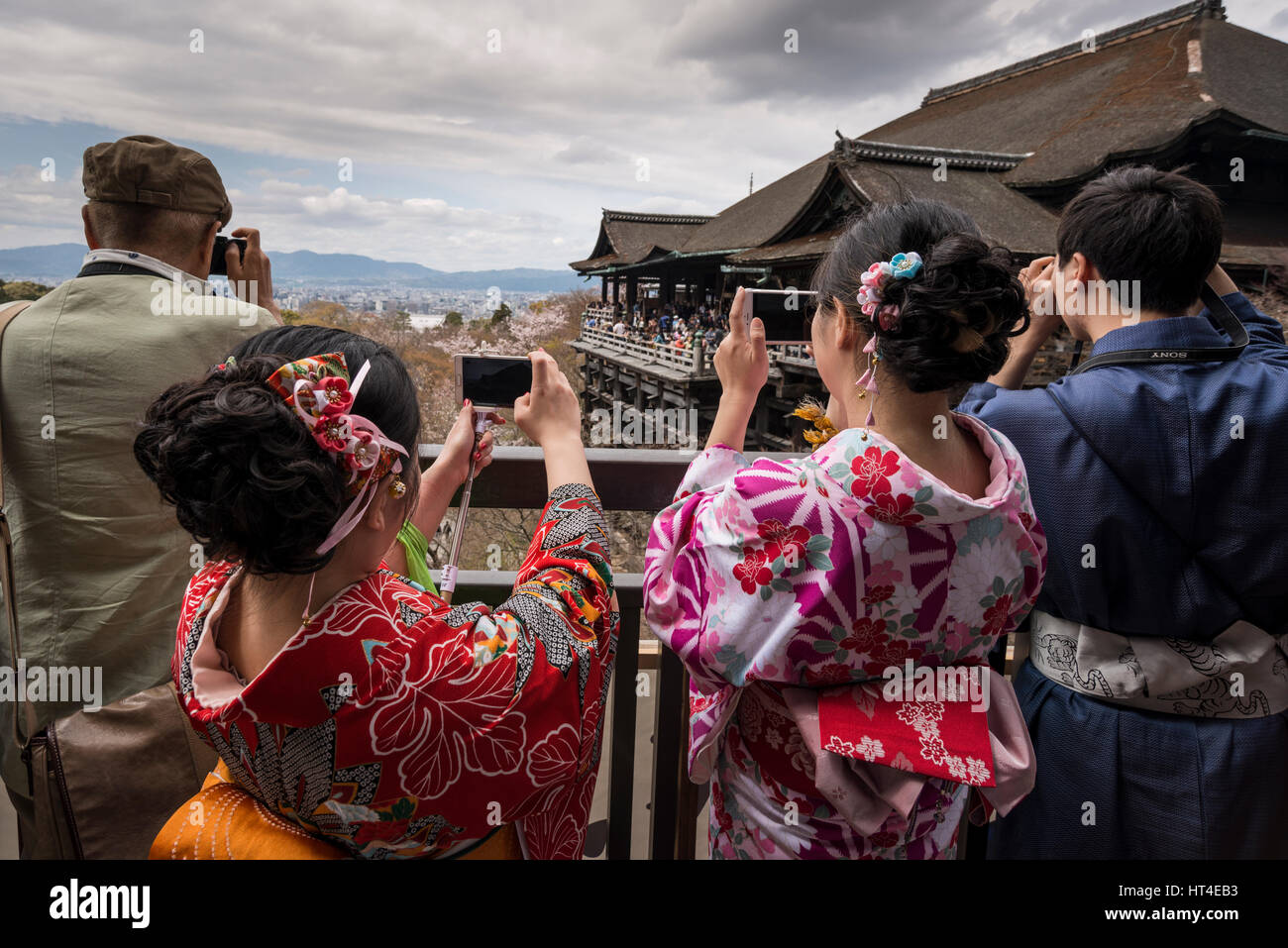 Young female tourists in Kimono, Japanese traditional costume, taking photos with their mobile phone, Kiyomzu dera, Kyoto, Japan Stock Photo