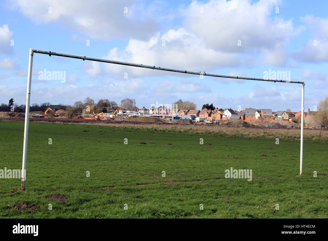 New house building taking place in the UK alongside a football pitch Stock Photo