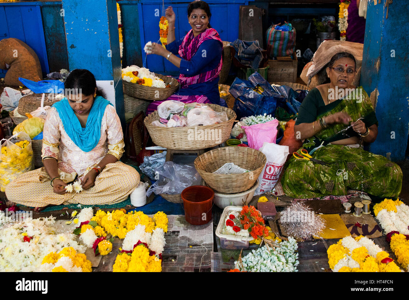 Women selling flowers at the Mapusa Market in North Goa, India. People from the surrounding come to Mapusa to sell their wares. Unlike other tourist-o Stock Photo