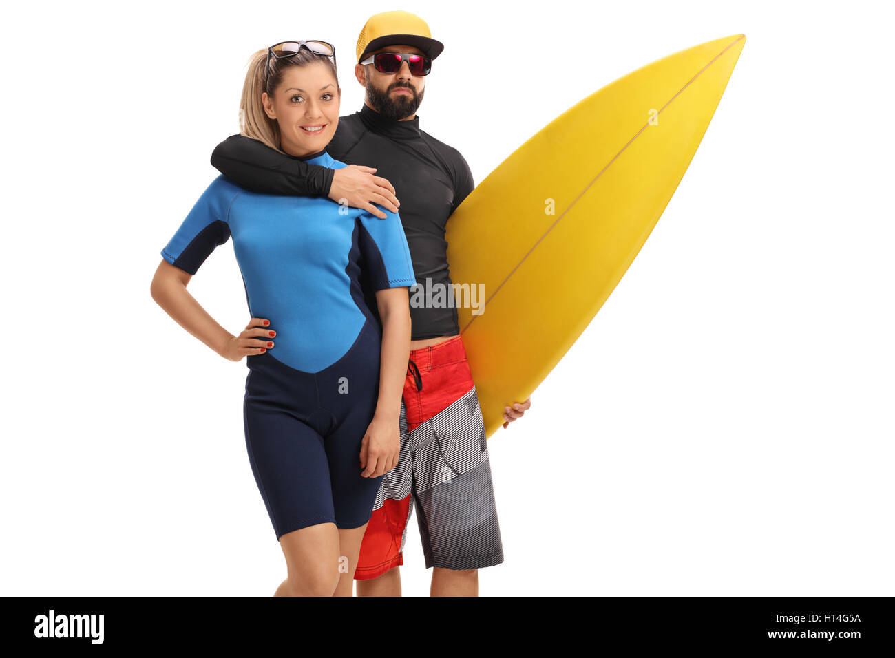 Female surfer with a male surfer holding a surfboard isolated on white background Stock Photo